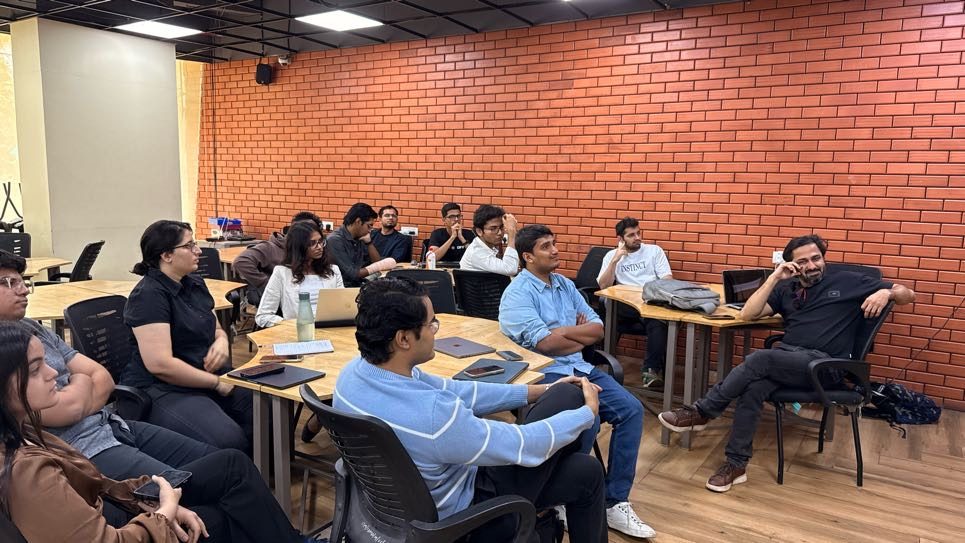 the audience seated at tables, watching a talk